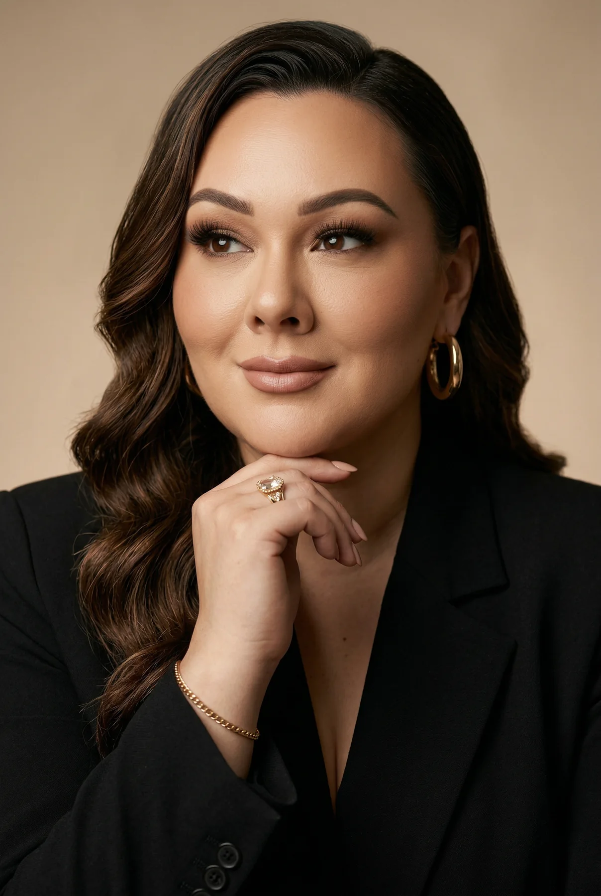 An editorial business portrait of a confident woman in a black blazer