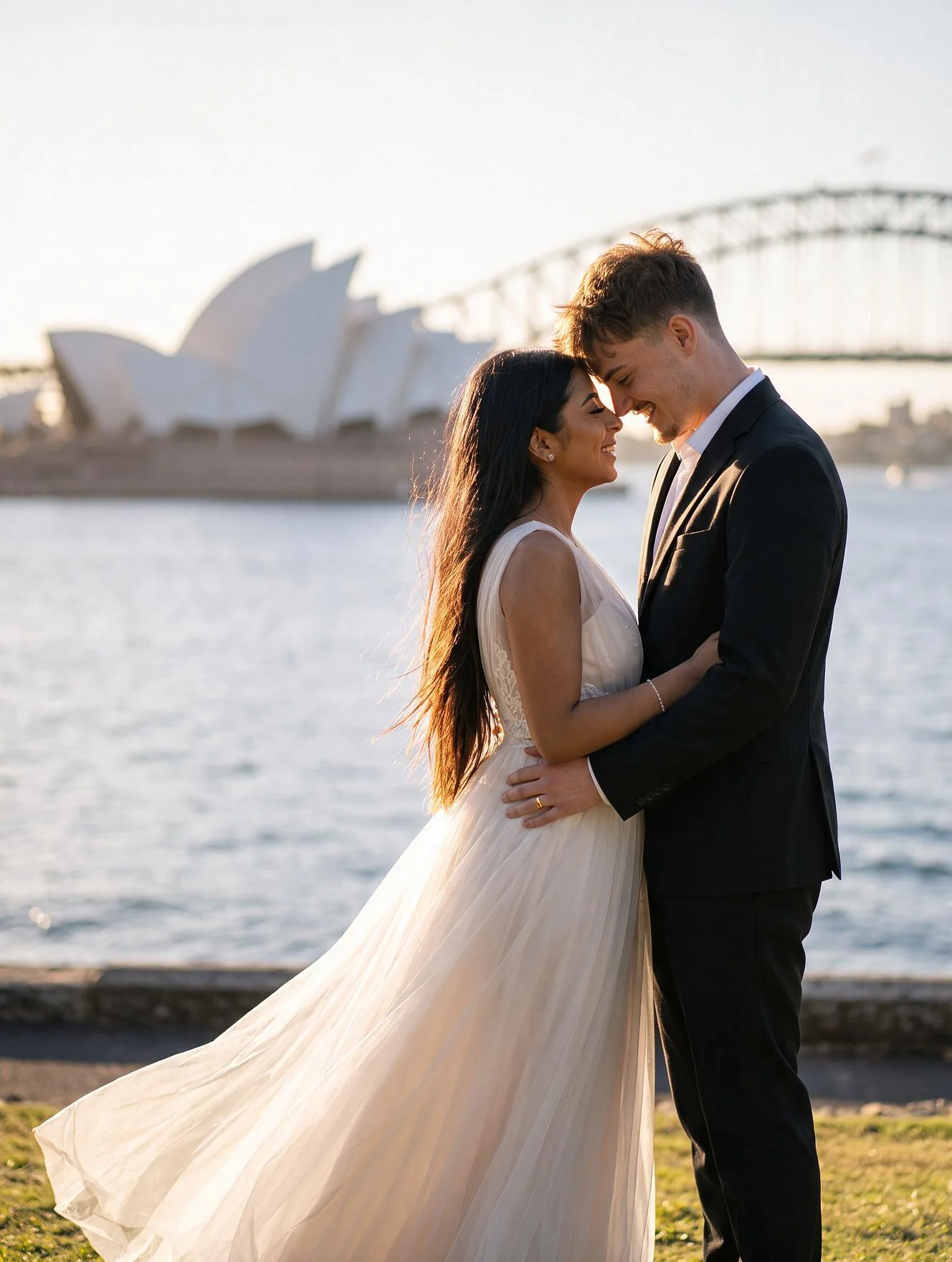 A bride and groom sharing a quiet moment beside Sydney Harbour