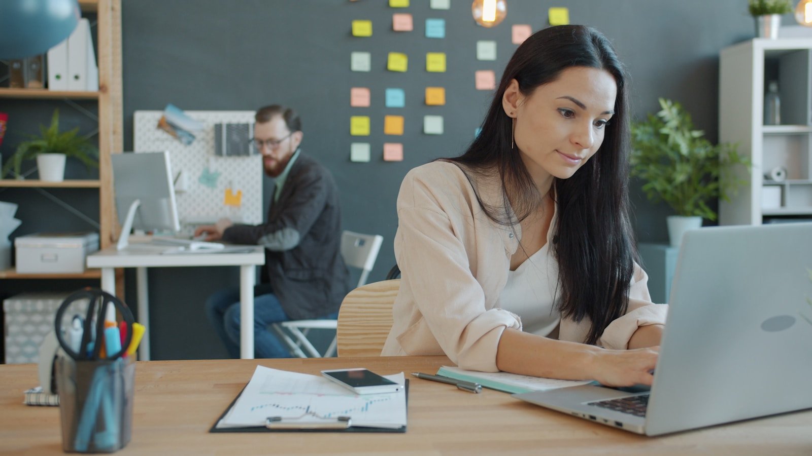 A creative team working with laptops in a contemporary office